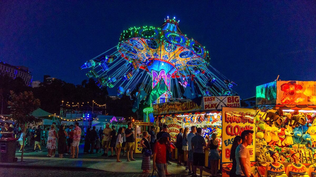 image showing a carnival ride and stalls at night at WA Cider and Pork Festival